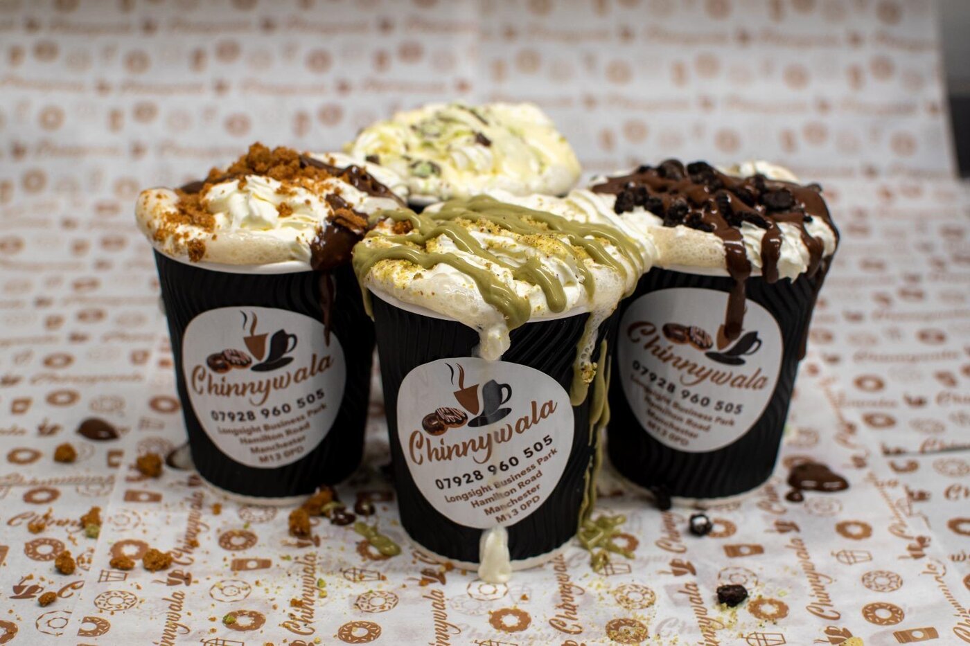 Loaded specialty hot drinks topped with cream, chocolate and biscoff